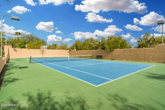 view of sport court featuring fence