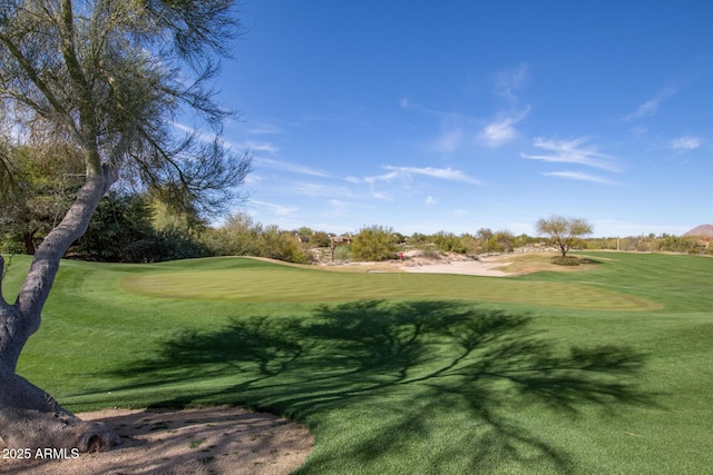 view of home's community featuring golf course view and a lawn