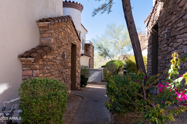 view of property exterior featuring stucco siding and a tile roof