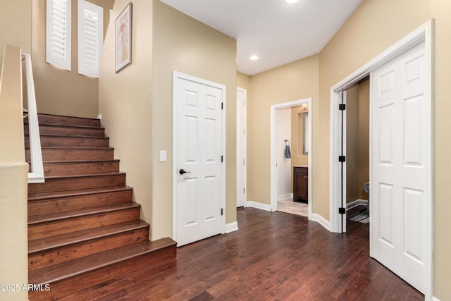 foyer featuring recessed lighting, baseboards, dark wood-style floors, and stairs