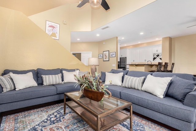 living area with recessed lighting, a ceiling fan, visible vents, and high vaulted ceiling