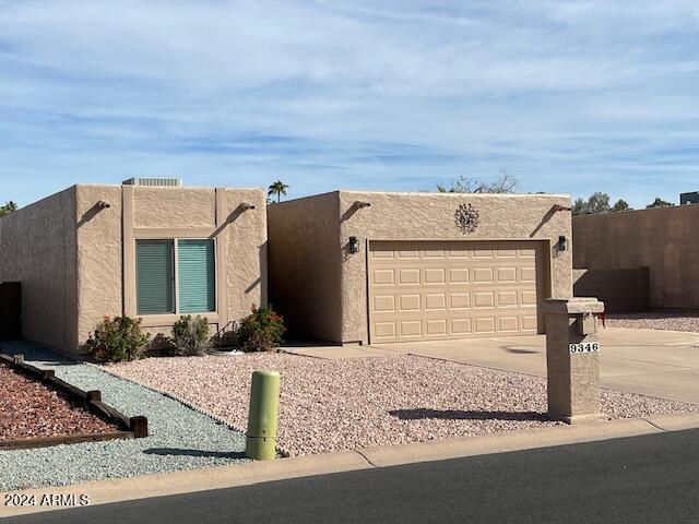 southwest-style home featuring a garage