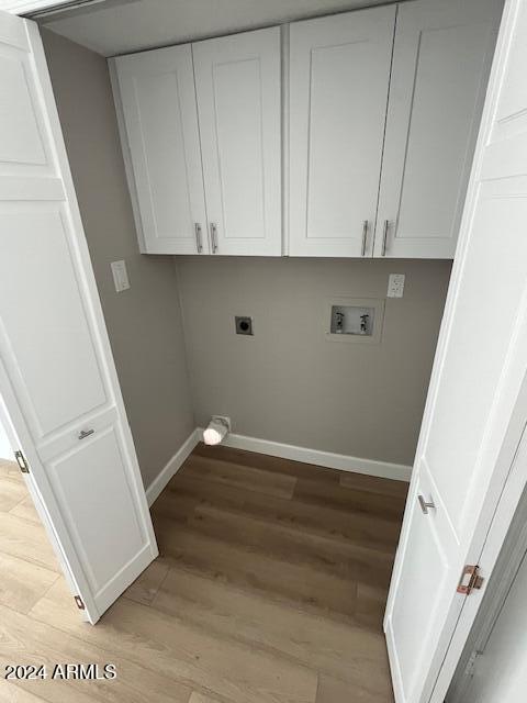 laundry area with hookup for a washing machine, light hardwood / wood-style flooring, and electric dryer hookup