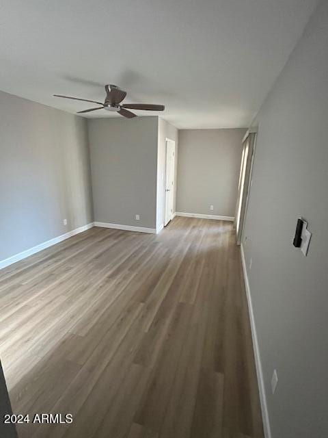 empty room featuring ceiling fan and hardwood / wood-style floors