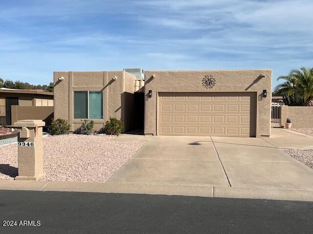 pueblo-style house with a garage