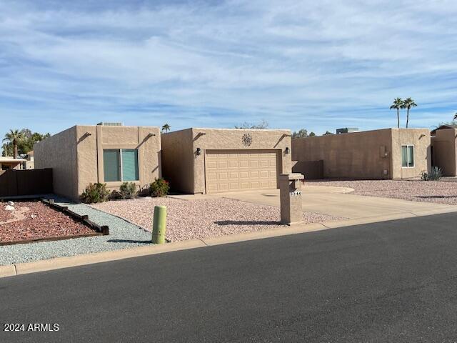 pueblo revival-style home featuring a garage