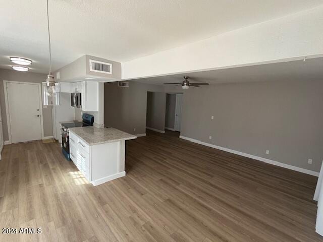 kitchen with white cabinets, dark hardwood / wood-style flooring, electric range, and decorative light fixtures