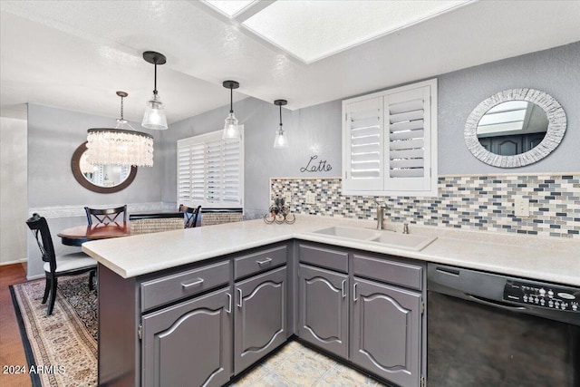 kitchen featuring gray cabinetry, dishwasher, sink, kitchen peninsula, and an inviting chandelier