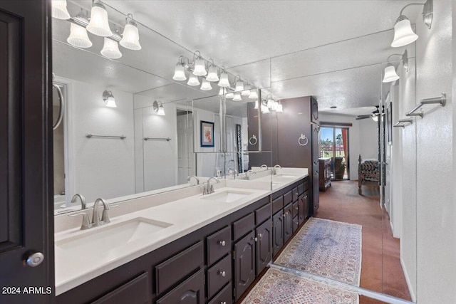 bathroom featuring vanity, a textured ceiling, tile patterned floors, and ceiling fan