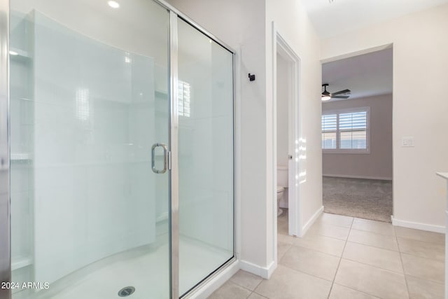 bathroom featuring tile patterned flooring, an enclosed shower, ceiling fan, and toilet