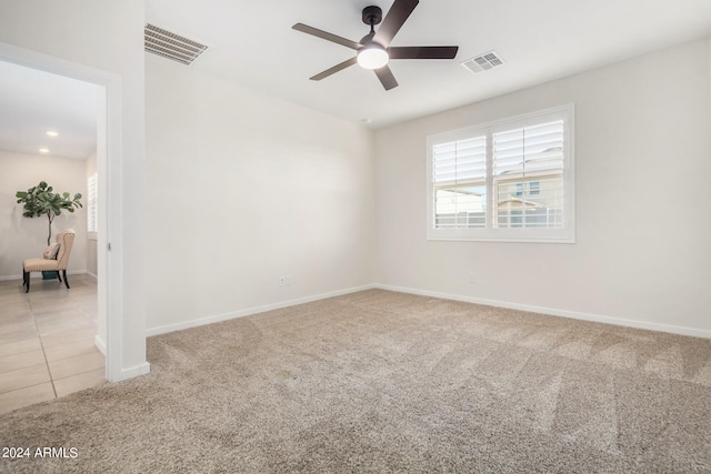 carpeted spare room with ceiling fan