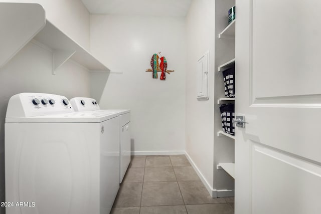 washroom with washing machine and dryer and light tile patterned floors