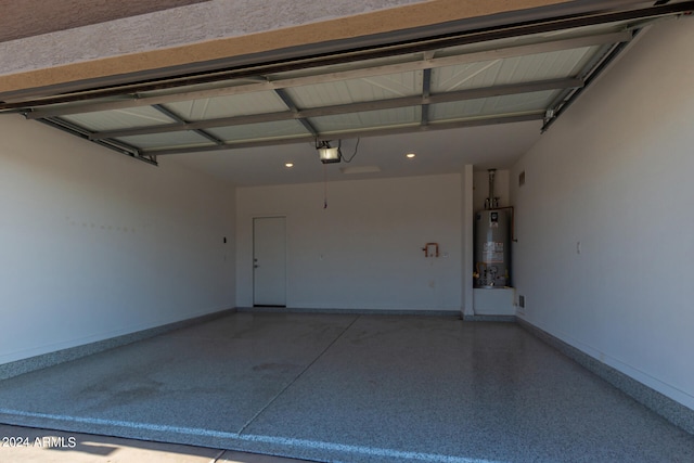 garage featuring gas water heater and a garage door opener