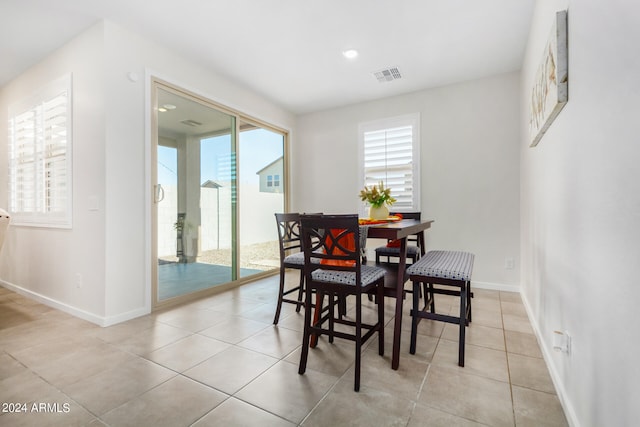 dining room with plenty of natural light and light tile patterned floors