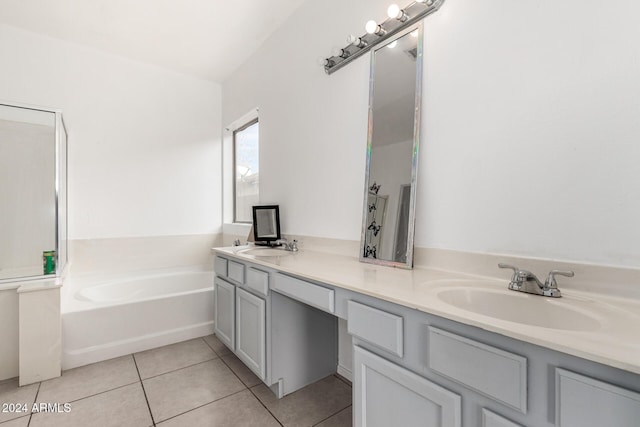 bathroom with tile patterned floors, vanity, and a tub