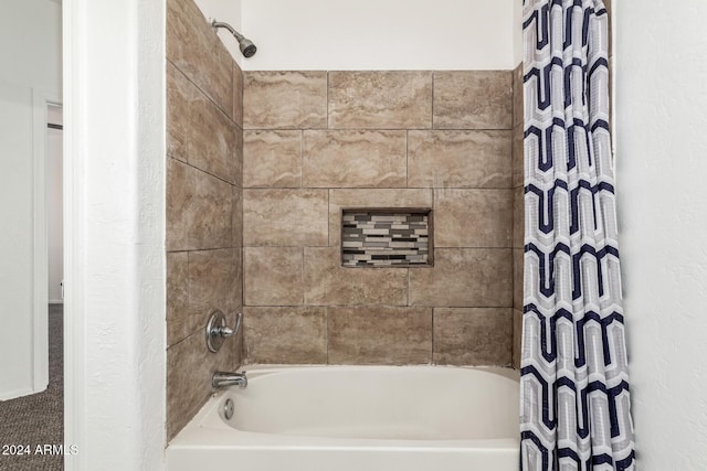 bathroom with shower / bath combo with shower curtain