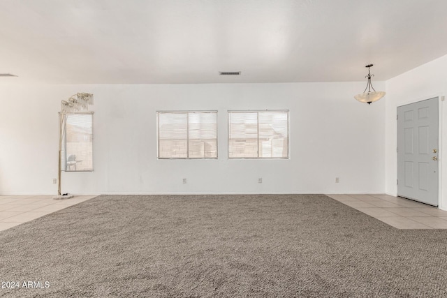 unfurnished room featuring light carpet