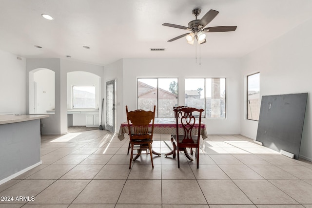 dining space with ceiling fan and light tile patterned floors