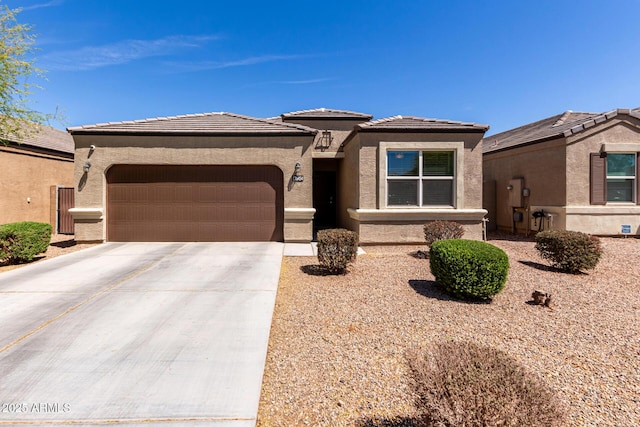 36454 W Picasso St, Maricopa, AZ 85138 - view of front facade featuring an attached garage, concrete driveway, stucco siding, and a tiled roof