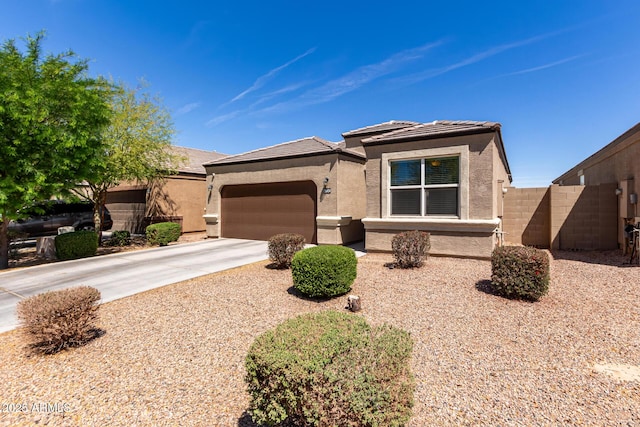 36454 W Picasso St, Maricopa, AZ 85138 - view of front of house with stucco siding, concrete driveway, an attached garage, fence, and a tiled roof