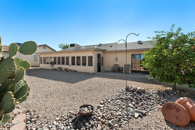 back of property with a patio