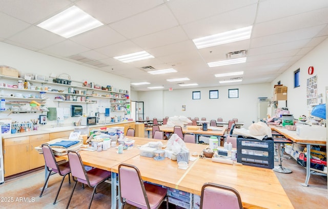 dining space featuring a drop ceiling