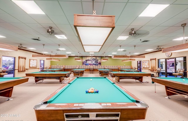 rec room with a paneled ceiling, ceiling fan, carpet floors, and billiards