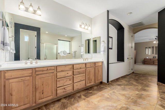 bathroom featuring ceiling fan, a shower with door, and vanity