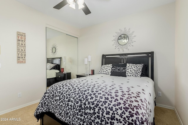 bedroom with ceiling fan, carpet floors, and a closet