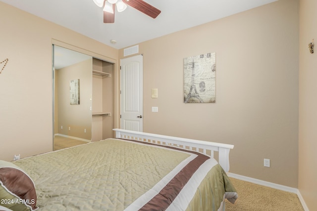 carpeted bedroom featuring a closet and ceiling fan