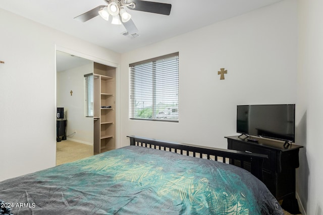 carpeted bedroom featuring ceiling fan and a closet