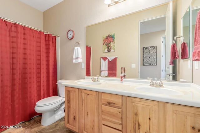 bathroom with tile patterned flooring, vanity, and toilet