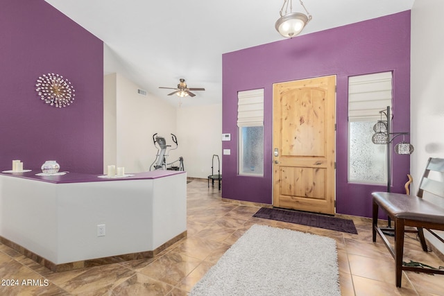 entryway featuring ceiling fan and light tile patterned floors