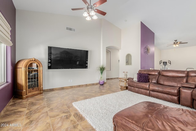 living room with ceiling fan and high vaulted ceiling