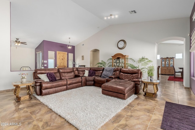 living room with high vaulted ceiling and ceiling fan