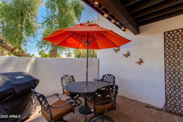 view of patio / terrace with a grill, a fenced backyard, and outdoor dining space