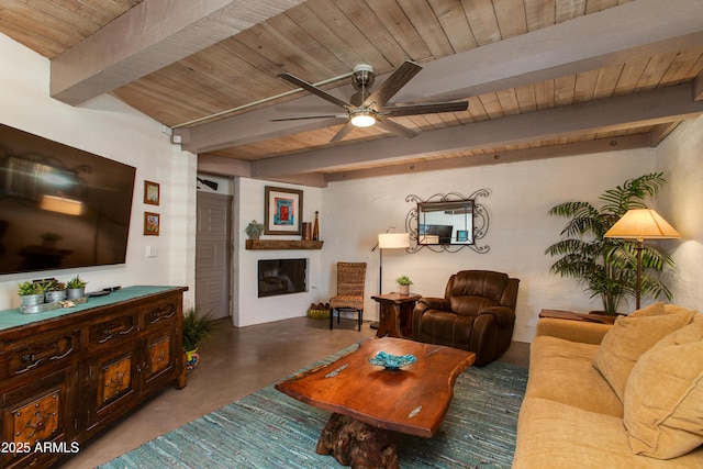 living area with wood ceiling, beam ceiling, a ceiling fan, finished concrete floors, and a fireplace
