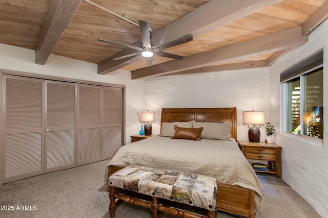 bedroom with wooden ceiling, beamed ceiling, carpet floors, a closet, and ceiling fan