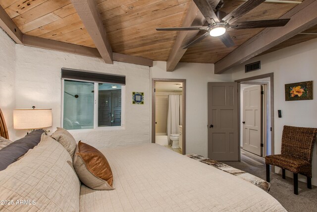 carpeted bedroom with wooden ceiling, beam ceiling, ensuite bathroom, and ceiling fan
