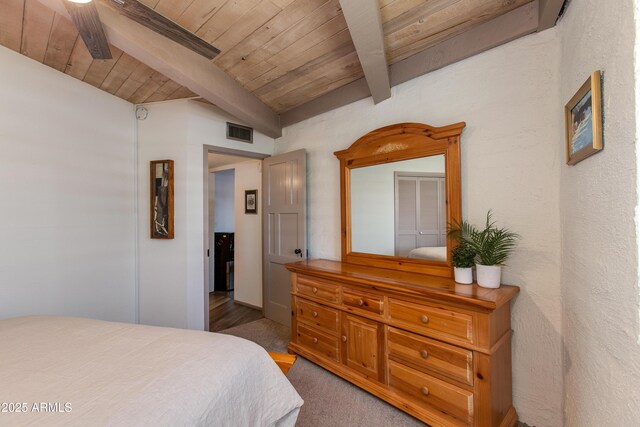 bedroom featuring beamed ceiling and wooden ceiling