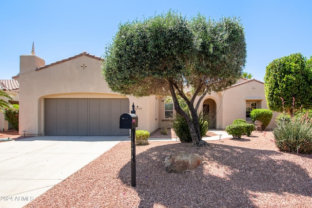 mediterranean / spanish house featuring a garage