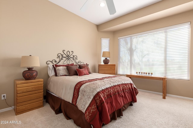 bedroom featuring ceiling fan, light colored carpet, and lofted ceiling