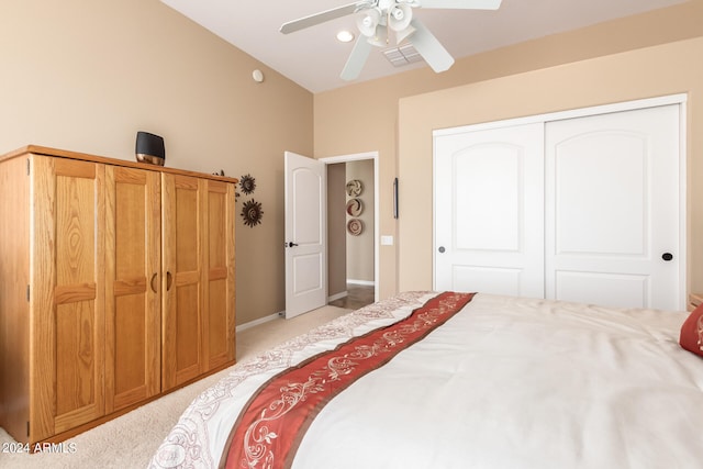 carpeted bedroom with ceiling fan and a closet