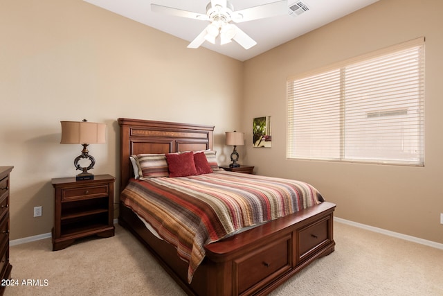 bedroom with ceiling fan and light carpet