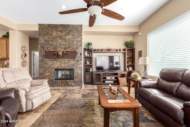 living room featuring a fireplace and ceiling fan