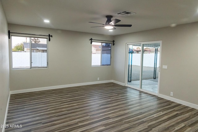 empty room featuring ceiling fan and dark hardwood / wood-style floors