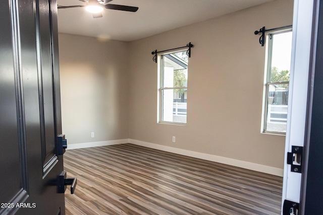 spare room featuring ceiling fan and dark hardwood / wood-style flooring