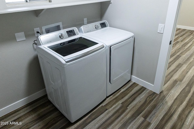 washroom featuring dark wood-type flooring and independent washer and dryer