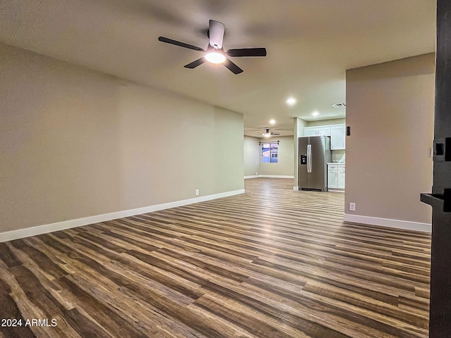 unfurnished living room featuring dark hardwood / wood-style floors and ceiling fan