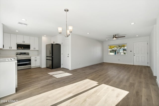 kitchen featuring ceiling fan with notable chandelier, stainless steel appliances, light hardwood / wood-style flooring, white cabinets, and hanging light fixtures